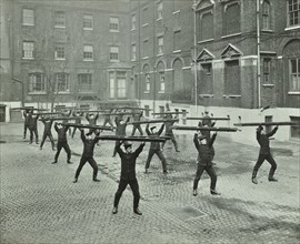 Firemen carrying out scaling ladder drill, London Fire Brigade Headquarters, 1910. Artist: Unknown.