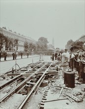 Workmen extending tramlines, Brixton Road, London, 1907. Artist: Unknown.