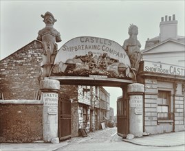 Ships' figureheads over the gate at Castle's Shipbreaking Yard, Westminster, London, 1909. Artist: Unknown.