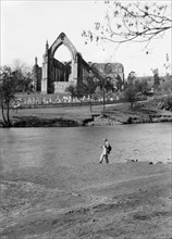 A fisherman on the River Wharfe in front of the ruins of Bolton Priory, North Yorkshire, 1940