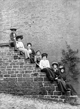Women sitting on steps of an unidentified building, Hellidon, Northamptonshire, c1896-c1920