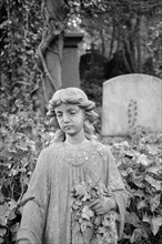 Statue of a girl holding flowers, Highgate Cemetery, Hampstead, London, 1995