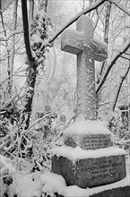 Cross on a grave in Highgate Cemetery, Hampstead, London, c1980-c1984