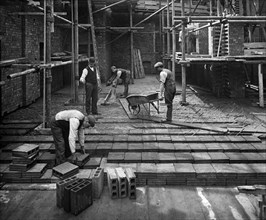 Construction workers laying a hollow pot floor, 8 Lloyds Avenue, City of London, 1907
