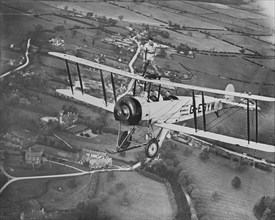 Man wing walking on an Avro 504 biplane without a harness, 20th century