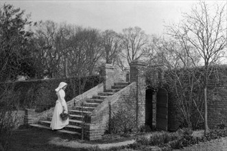 Woman standing at the base of the garden steps, Ufton Court, Ufton Nervet, Berkshire. c1901