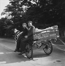 Two men seated on a horse and cart on a road, West Yorkshire, 1966-1974