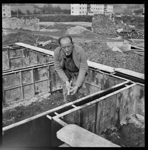 Builder working on the Penhill Estate, Swindon, Wiltshire, 1955
