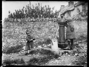 Two children collecting water at a water pump, Cheddar, Somerset, 1907