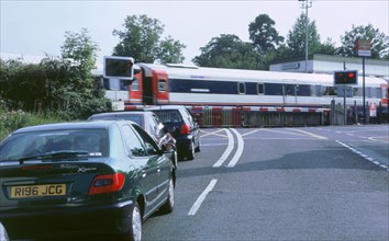 Traffic queue at level crossing in Brockenhurst, Hampshire. Artist: Unknown.