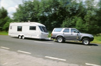 1995 Toyota Landcruiser towing large caravan at speed. Artist: Unknown.