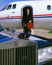 1987 Rolls Royce Silver Spirit with executive disembarking jet. Artist: Unknown.