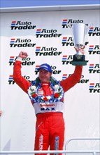 Matt Neal, Nissan driver, celebrates victory, 1999 British touring cars. Artist: Unknown.