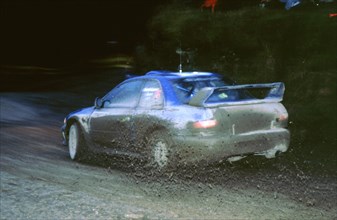 Juha Kankkunen, 1999 Subaru Impreza,  WRC Network Q Rally. Artist: Unknown.