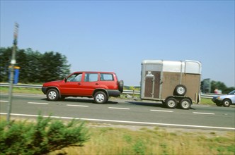 1997Ford Maverick towing horse box. Artist: Unknown.