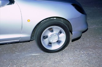 Wheel spin on 1998 Ford Puma producing smoke. Artist: Unknown.