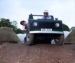 Child driving a toy Land Rover. Artist: Unknown.