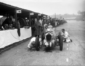 Mechanics working on the MG of Doreen Evans, JCC International Trophy, Brooklands, 1936. Artist: Bill Brunell.