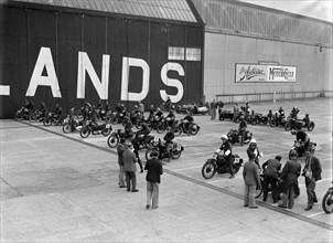 Motorcycles on the start line at the MCC Members Meeting, Brooklands, 10 September 1938. Artist: Bill Brunell.