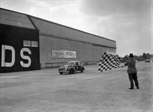 HJ Ripley's SS Jaguar taking the chequered flag, MCC Members Meeting, Brooklands, 10 September 1938. Artist: Bill Brunell.