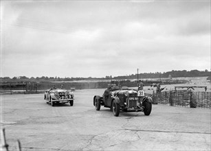 AP Watson's Lagonda and AS Lusty's Riley Lynx at the chicane, JCC Members Day, Brooklands, 1939. Artist: Bill Brunell.