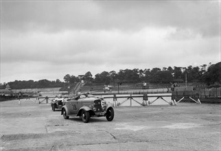 J Cleland's Ford V8 and JH Barker's Riley Lynx at the chicane, JCC Members Day, Brooklands, 1939. Artist: Bill Brunell.