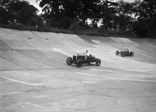 Vauxhall 30/98 and Bugatti Type 37 racing on the banking at Brooklands. Artist: Bill Brunell.