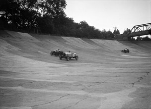 Alvis 17 and Austin 747 cc racing on the banking at Brooklands. Artist: Bill Brunell.