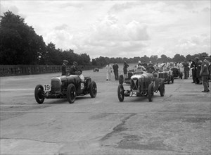 Aston Martins, Salmson and MG at the start of the LCC Relay GP, Brooklands, 25 July 1931. Artist: Bill Brunell.