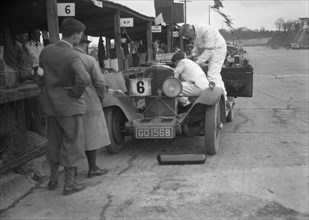 Talbot 90 of E and SJ Burt in the pits at the JCC Double Twelve race, Brooklands,  May 1931. Artist: Bill Brunell.