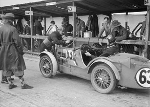 MG C type of TVG Selby and G Hendy in the pits at the JCC Double Twelve race, Brooklands, May 1931. Artist: Bill Brunell.