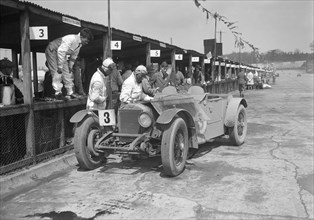 Invicta of FH Cairnes and George Field in the pits at the JCC Double Twelve race, Brooklands, 1931. Artist: Bill Brunell.