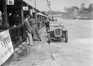 Austin Ulster of ECH Randall and WE Harker in the pits, JCC Double Twelve race, Brooklands, 1931. Artist: Bill Brunell.