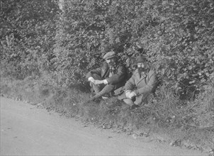 Two men taking a rest during the Bugatti Owners Club car treasure hunt, 25 October 1931. Artist: Bill Brunell.