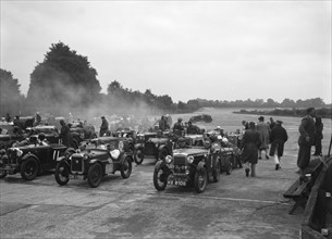 Cars on the starting grid for the Brighton & Hove Motor Club High Speed Trial, Brooklands, c1931. Artist: Bill Brunell.