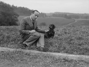 British racing driver Charles Mortimer and his pet dachshund, c1930s Artist: Bill Brunell.