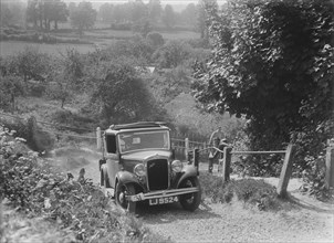 1934 Austin Ten taking part in a West Hants Light Car Club Trial, Ibberton Hill, Dorset, 1930s. Artist: Bill Brunell.