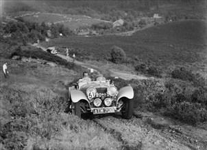 1936 Jaguar SS100 taking part in the NWLMC Lawrence Cup Trial, 1937. Artist: Bill Brunell.