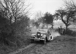 Lord Avebury's Ford V8 competing in the Sunbac Colmore Trial, Gloucestershire, 1934. Artist: Bill Brunell.