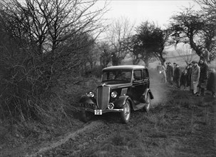 EGH Arnold's Ford Model Y, Sunbac Colmore Trial, near Winchcombe, Gloucestershire, 1934. Artist: Bill Brunell.
