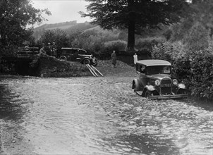 Ford Model A of JW Robbins fording the River Exe at Yealscombe, Devon, JCC Lynton Trial, 1932. Artist: Bill Brunell.