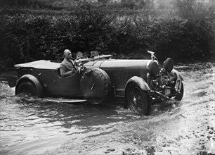 3-litre Lagonda of RD Tong fording the River Exe at Yealscombe, Devon, JCC Lynton Trial, 1932. Artist: Bill Brunell.