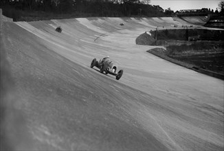 Bentley of Tim Birkin on the way to winning a race at a BARC meeting, Brooklands, 1930. Artist: Bill Brunell.