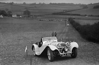Jaguar SS100 at the Standard Car Owners Club Southern Counties Trial, 1938. Artist: Bill Brunell.