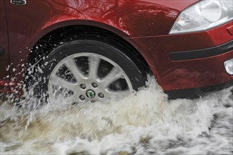 Car driving through flood. Artist: Unknown.