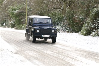 2002 Land Rover Defender driving on snowy road, 2009 Artist: Unknown.