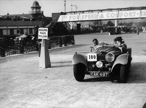 1938 S.S. 100 at Brooklands suring Junior Car Club event 25th March 1939 Artist: Unknown.