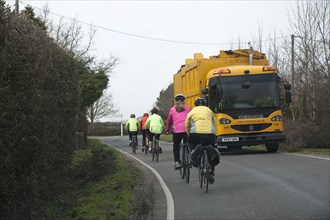 Group of cylists encounter refuse truck on country road in New Forest 2014 Artist: Unknown.