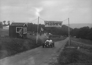 Car crossing the finishing line at the MAC Shelsley Walsh Speed Hill Climb, Worcestershire, 1935. Artist: Bill Brunell.