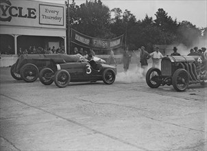 Fiat, Bugatti and Benz competing at a Surbiton Motor Club race meeting, Brooklands, Surrey, 1928. Artist: Bill Brunell.